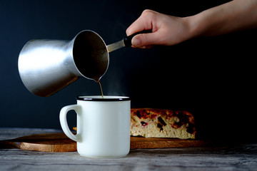 Fresh coffee in a white mug with a fruit pie