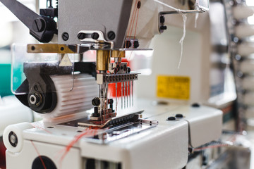 Closeup detail of the sewing machine. Sewing process in the phase of overstitching
