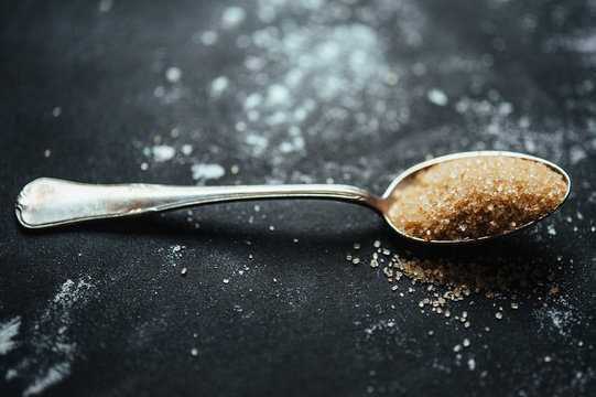 Heap of Brown Sugar Placed on an Old Silver Spoon