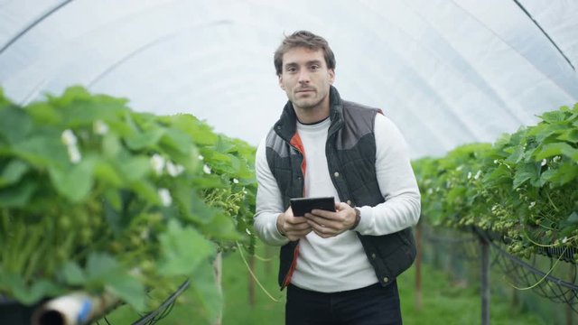  Portrait of smiling farm worker with computer tablet in fruit orchard