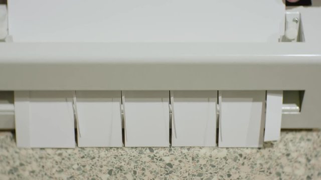 Specialized cutter for business cards cuts white sheets of paper