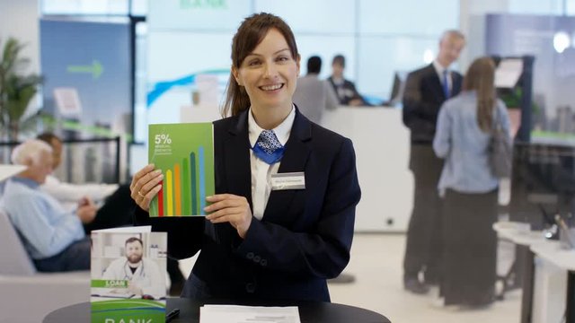  Friendly bank worker talking to customer as seen from customer's pov