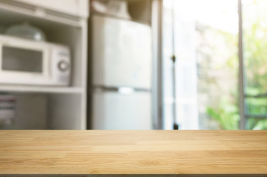 empty wooden table in front of blurred home kitchen background