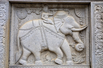 Stone bas relief of elephants in buddhists' temple