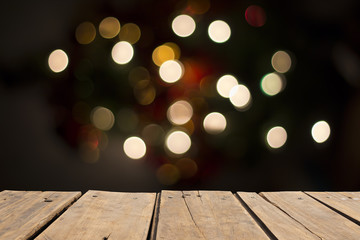 wooden table in front of abstract blurred ligth