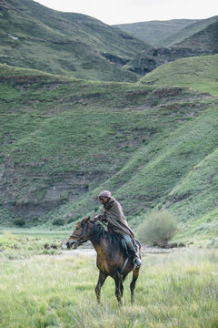 young Basotho herdsman with his horse in the Lesotho highlands