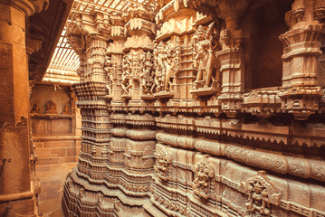 Symbolic sculptures and reliefs in Indian temple wall. Ancient architecture example with Hindu and...