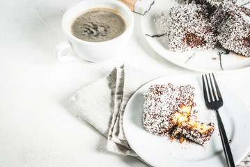 Australian food. Traditional dessert Lamington - pieces of biscuit in dark chocolate, sprinkled...
