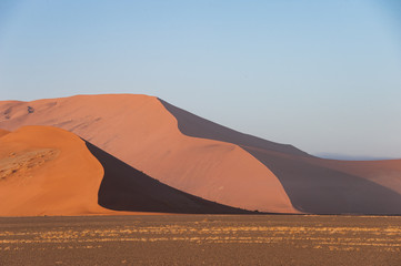Fototapeta na wymiar Arrowhead shape formed by shadows on the sand dunes in Sossusvlei, Namibia