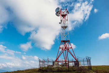 Telecommunications tower and satellite dish telecom network in mountains