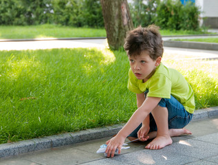 boys playing with a plane outdoors in the park