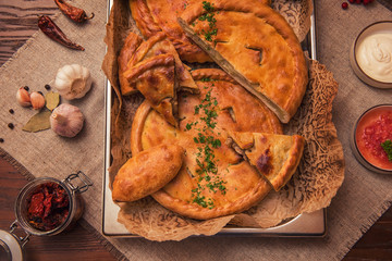 Different pies from meat and vegetables. Freshly baked cakes on a table