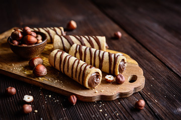 Biscuit tubes filled with hazelnut cream and chocolate topping