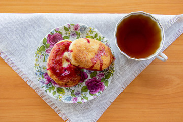 hot pie with berries, fried in oil, lined in a dish, a mug of cold milk, on a napkin