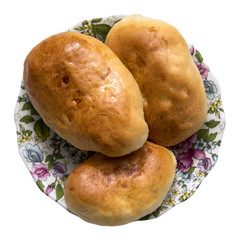 fresh only baked fluffy hot pies with orange crust oiled lie on a thin porcelain saucer isolated on white