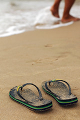 Fototapeta na wymiar flip flops on the seashore