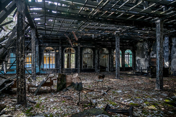 Fototapeta na wymiar Burned-out ruins of mansion interior after fire