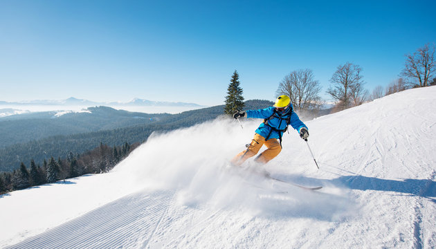 Shot of a professional skier riding the slope in a beautiful winter day copyspace ski resort recreation travelling tourism vacation extreme adrenaline