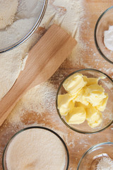 Baking ingredients on kitchen table. White products prepare for cooking on wooden cutting board. Lifestile food concept.