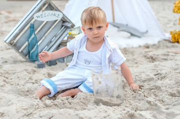 Boy playing with sand on a beach