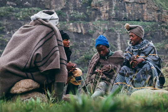 A group of Basotho herdsmen sitting and talking in the mountains