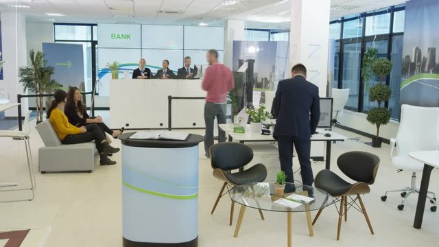  Time lapse of busy modern bank, friendly staff assisting customers