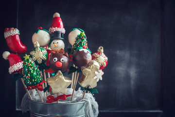 Close up to Christmas cake pops on dark background with blank space