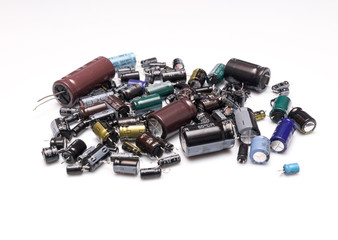 old electrolytic capacitors of different values isolated on a white background, Concept recycling 