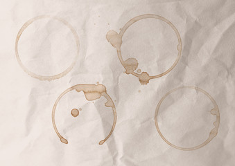 Circular coffee stains on a paper background