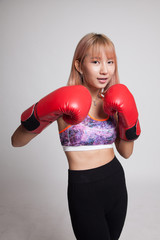 Beautiful healthy Asian girl with red boxing glove.