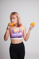 Beautiful Asian healthy girl with orange juice and orange fruit.