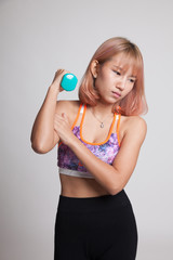 Asian healthy girl got arm pain with dumbbell.