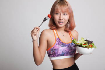 Beautiful Asian healthy girl enjoy eating  salad.