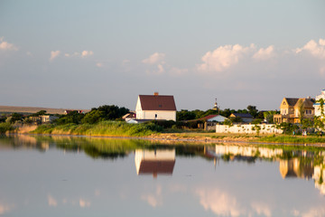Naklejka na ściany i meble reflection of a house on the water