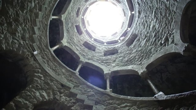 Background architecture loop. The Masonic Initiation well, the spiral staircase of Quinta da Regaleira in Sintra, Portugal.