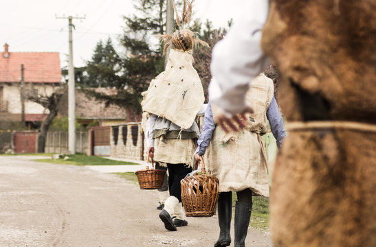 Old Slavic tradition of casting out evil powers with young males waking dressed like forest spirits and singing from door to door