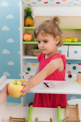 A little girl playing in the kindergarten