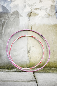 Two hula hoops by a wall