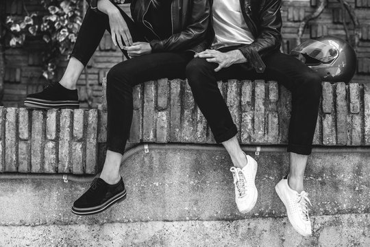 Closeup of biker couple sitting on the street.