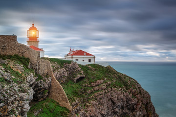 Fototapeta na wymiar Lighthouse shines out to sea ships. Sagres Cabo Sao Vicente