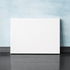 Mock-up poster in the interior. Blank horizontal canvas. Blue wall on background.