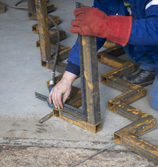 welder is controlling angle of iron construction