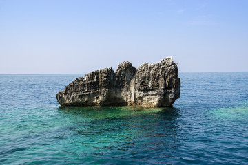 Rock Formation In The Sea Against Clear Blue Sky