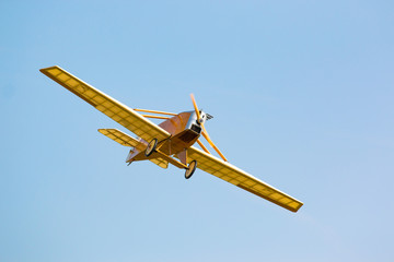 Vintage yellow airplane in blue sky