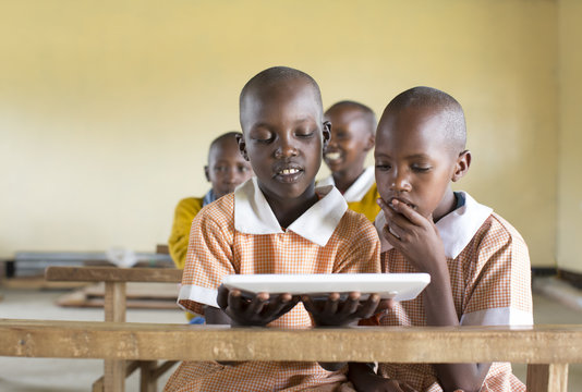 School girls using tablet computer in the classroom