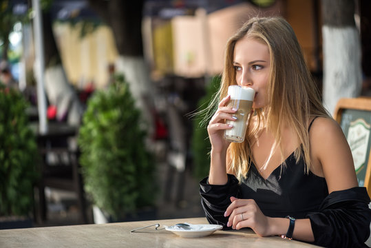 Blonde Drinking Coffe In A Cafe