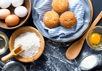Baking ingredients. Bowl, eggs, flour, eggbeater, rolling pin and eggshells on black chalkboard...