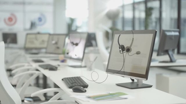  Workstations in a telesales office, headsets on computer monitors