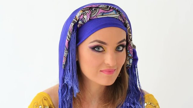 Clouse up of beautiful girl in arabian style and make up in white backgraund 