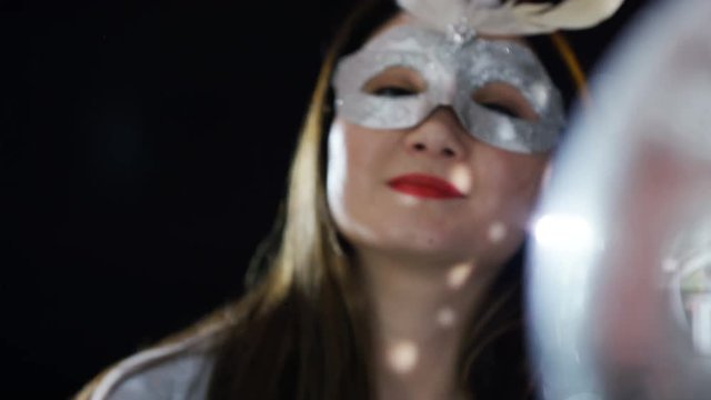  Beautiful girl wearing carnival mask at glamorous party